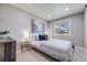 Serene bedroom with a comfy bed, neutral color scheme, and a large window offering natural light at 6893 S High St, Centennial, CO 80122