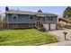Well-manicured two-story home with brick accents, a lawn, and mature trees at 6893 S High St, Centennial, CO 80122