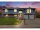 Charming two-story home featuring a well-manicured lawn, brick accents, and a two-car garage at 6893 S High St, Centennial, CO 80122