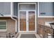 Close-up of the front entry featuring a double-door and brick facade at 6893 S High St, Centennial, CO 80122