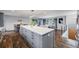 Open-concept living room and kitchen featuring hardwood floors and modern decor at 6893 S High St, Centennial, CO 80122