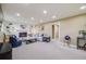 Cozy living room with a fireplace, built-in shelving and recessed lighting at 6893 S High St, Centennial, CO 80122