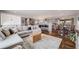 Bright and airy living room showcases seamless flow into the modern kitchen and dining area at 6893 S High St, Centennial, CO 80122