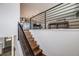 Staircase landing with modern railing and view into the kitchen and living room at 6893 S High St, Centennial, CO 80122