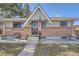 Lovely brick-clad house with a well-maintained front yard, accented by mature trees and an inviting entrance at 791 S Routt Way, Lakewood, CO 80226