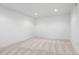 A carpeted bedroom features neutral walls and recessed lighting, offering a cozy and bright space at 5698 E Greenwood Pl, Denver, CO 80222