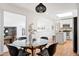 Bright dining area with modern lighting adjacent to the updated kitchen at 5698 E Greenwood Pl, Denver, CO 80222