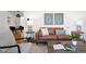 Stylish living room with designer furnishings, hardwood floors, and eye-catching art at 5698 E Greenwood Pl, Denver, CO 80222