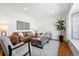 Bright living room features hardwood floors, large windows and stylish furniture at 5698 E Greenwood Pl, Denver, CO 80222