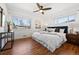 Serene primary bedroom with hardwood floors, a large window, and stylish decor at 5698 E Greenwood Pl, Denver, CO 80222