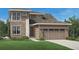 Beautiful two-story home featuring stone accents, a two-car garage, and manicured front yard at 3027 Newfound Lake Rd, Berthoud, CO 80513