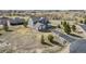 Aerial view of the backyard of a two-story home, the driveway, and the golf course in the distance at 5285 La Quinta Cir, Elizabeth, CO 80107