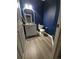 A bright bathroom with blue walls features a white vanity and toilet, plus modern flooring at 5285 La Quinta Cir, Elizabeth, CO 80107