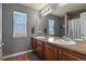 Bathroom featuring neutral walls, carpet flooring, a window letting in natural light, dual sinks and a shower/tub at 5285 La Quinta Cir, Elizabeth, CO 80107