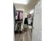 Spacious walk-in closet featuring custom shelving and hardwood floors for organized storage at 5285 La Quinta Cir, Elizabeth, CO 80107
