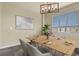 Bright dining room with a modern chandelier and large window at 5285 La Quinta Cir, Elizabeth, CO 80107