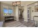 Inviting entryway with hardwood floors, a decorative chandelier, and large windows providing natural light at 5285 La Quinta Cir, Elizabeth, CO 80107