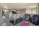 Spacious exercise area equipped with a treadmill, weights, sauna, and a view into a bonus room at 5285 La Quinta Cir, Elizabeth, CO 80107