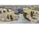 Charming home boasts a long driveway and a landscaped front yard, complementing its blue siding at 5285 La Quinta Cir, Elizabeth, CO 80107