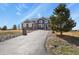 A low-angle view of a two-story home with stone accents and a well-maintained yard at 5285 La Quinta Cir, Elizabeth, CO 80107
