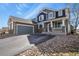 Two-story home showcasing a stone-accented garage, light-colored trim and front porch at 5285 La Quinta Cir, Elizabeth, CO 80107