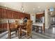 Inviting kitchen with wood cabinets, a center island, and bar stool seating at 5285 La Quinta Cir, Elizabeth, CO 80107