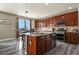 Spacious kitchen with dark wood cabinetry and stainless steel appliances at 5285 La Quinta Cir, Elizabeth, CO 80107
