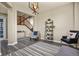 Cozy living room featuring hardwood floors, a wooden staircase, and modern decor at 5285 La Quinta Cir, Elizabeth, CO 80107