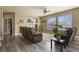 Inviting living room featuring large windows, a fireplace with mantel, and comfortable seating at 5285 La Quinta Cir, Elizabeth, CO 80107
