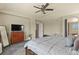 Bedroom boasts a large bed, dresser, mounted TV, carpet flooring, and a ceiling fan at 5285 La Quinta Cir, Elizabeth, CO 80107