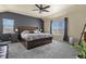 Spacious main bedroom featuring a gray accent wall, neutral walls, carpet flooring, and a ceiling fan at 5285 La Quinta Cir, Elizabeth, CO 80107