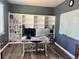 Bright office with modern desk, monitor, and built-in bookshelves at 5285 La Quinta Cir, Elizabeth, CO 80107