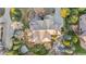 An aerial view displays a Tudor-style home's spacious backyard, deck, patio, and landscaped areas at 35 Brookhaven Ln, Littleton, CO 80123