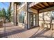 Beautiful back porch featuring stone accents, wood beams, and windows at 35 Brookhaven Ln, Littleton, CO 80123