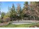 This backyard features a basketball court, rock wall, mature trees, and lush landscaping at 35 Brookhaven Ln, Littleton, CO 80123