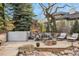 Inviting backyard patio with fireplace, spa, and lounge area at 35 Brookhaven Ln, Littleton, CO 80123