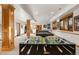 Spacious finished basement featuring a foosball table, pool table, and bar at 35 Brookhaven Ln, Littleton, CO 80123