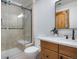 A bathroom with glass-enclosed shower, and wood vanity with black hardware and white countertop at 35 Brookhaven Ln, Littleton, CO 80123