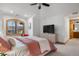 A bedroom with neutral paint, shuttered windows, and an archway that leads to the ensuite at 35 Brookhaven Ln, Littleton, CO 80123