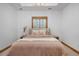 Serene bedroom with neutral tones, plush bedding, and a cozy window at 35 Brookhaven Ln, Littleton, CO 80123