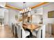Bright dining room with modern lighting, wood floors, and staircase views at 35 Brookhaven Ln, Littleton, CO 80123