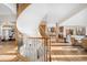 Open foyer showcases a winding staircase and views of the dining room, kitchen and living room at 35 Brookhaven Ln, Littleton, CO 80123