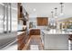 Bright kitchen featuring stainless steel appliances, center island with bar seating, and open floor plan at 35 Brookhaven Ln, Littleton, CO 80123