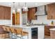 Well-appointed kitchen with an island, bar stools, stainless steel appliances, and custom cabinetry at 35 Brookhaven Ln, Littleton, CO 80123
