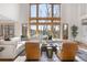 Bright, open living area with large windows, hardwood floors, and comfortable seating arrangement at 35 Brookhaven Ln, Littleton, CO 80123