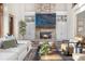Cozy living room featuring a stone fireplace, built-in shelving, and comfortable seating at 35 Brookhaven Ln, Littleton, CO 80123