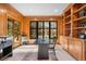 A home office with wood paneled walls, built-in shelves, and outside views at 35 Brookhaven Ln, Littleton, CO 80123