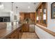 Elegant wet bar boasts wood cabinets, stainless steel appliances, and stone countertops at 35 Brookhaven Ln, Littleton, CO 80123