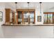 Charming wet bar features wooden cabinets, granite counters, and pendant lighting at 35 Brookhaven Ln, Littleton, CO 80123