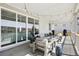 Inviting covered back porch with comfortable seating, string lights, and outdoor grill at 6361 Kenzie Cir, Castle Pines, CO 80108